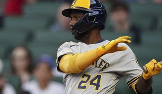 Milwaukee Brewers&#39; Andrew McCutchen hits a single in the first inning of a baseball game against the Atlanta Braves, Friday, May 6, 2022, in Atlanta. (AP Photo/John Bazemore)