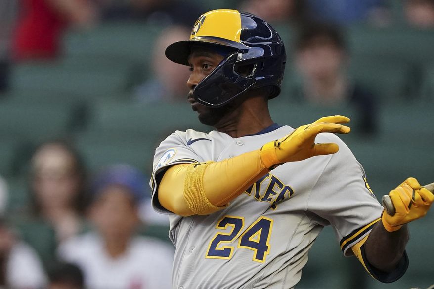 Milwaukee Brewers&#39; Andrew McCutchen hits a single in the first inning of a baseball game against the Atlanta Braves, Friday, May 6, 2022, in Atlanta. (AP Photo/John Bazemore)