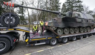 FILE - German soldiers load tank howitzers 2000 for transport to Lithuania at the Bundeswehr army base in Munster, northern Germany, Monday, Feb. 14, 2022. Germany&#39;s defense minister confirmed Friday that her country will supply Ukraine with seven powerful self-propelled howitzers to help defend itself against Russia. Christine Lambrecht said Ukrainian soldiers will be trained in Germany to use the self-propelled Panzerhaubitze 2000 artillery, which is capable of firing precision ammunition at a distance of up to 40 kilometers (25 miles). (AP Photo/Martin Meissner, File)