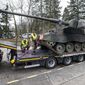 FILE - German soldiers load tank howitzers 2000 for transport to Lithuania at the Bundeswehr army base in Munster, northern Germany, Monday, Feb. 14, 2022. Germany&#x27;s defense minister confirmed Friday that her country will supply Ukraine with seven powerful self-propelled howitzers to help defend itself against Russia. Christine Lambrecht said Ukrainian soldiers will be trained in Germany to use the self-propelled Panzerhaubitze 2000 artillery, which is capable of firing precision ammunition at a distance of up to 40 kilometers (25 miles). (AP Photo/Martin Meissner, File)