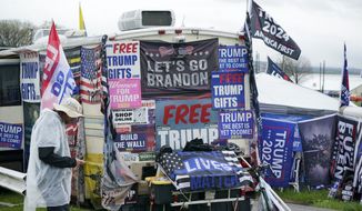 Trump merchandise is for sale during a campaign rally at the Westmoreland Fair Grounds in Greensburg, Pa, Friday, May 6, 2022. (AP Photo/Gene J. Puskar)