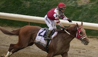Sonny Leon celebrates after riding Rich Strike to victory in the 148th running of the Kentucky Derby horse race at Churchill Downs Saturday, May 7, 2022, in Louisville, Ky. (AP Photo/Charlie Riedel) **FILE**