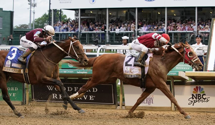 Rich Strike (21), with Sonny Leon aboard, beats Epicenter (3), with Joel Rosario aboard, at the finish line to win the 148th running of the Kentucky Derby horse race at Churchill Downs Saturday, May 7, 2022, in Louisville, Ky. (AP Photo/Mark Humphrey)