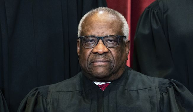 Justice Clarence Thomas sits during a group photo at the Supreme Court in Washington, on Friday, April 23, 2021, in this file photo. (Erin Schaff/The New York Times via AP, Pool, File)