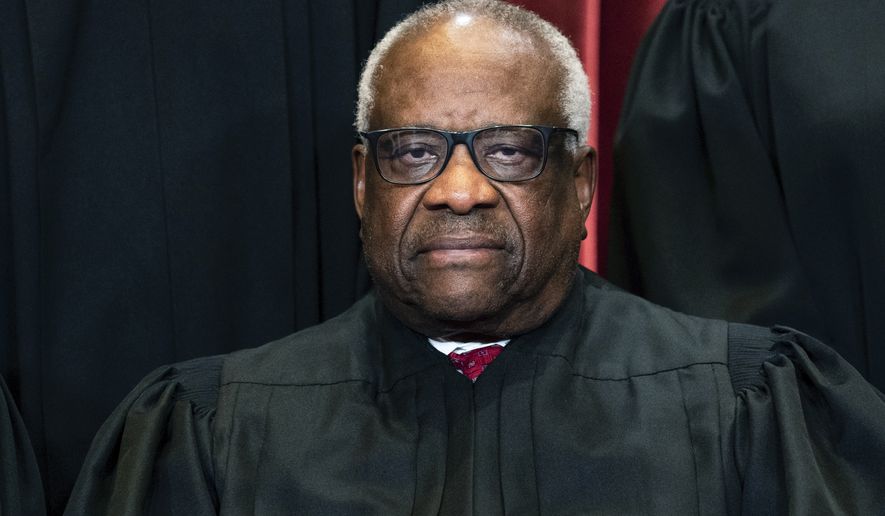 Justice Clarence Thomas sits during a group photo at the Supreme Court in Washington, on Friday, April 23, 2021, in this file photo. (Erin Schaff/The New York Times via AP, Pool, File)  **FILE**