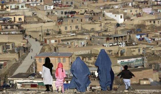 Burqa-clad women walk on Nadir Khan hilltop overlooking Kabul, Afghanistan on March 16, 2017. Afghanistan’s Taliban rulers on Saturday, May 7, 2022 ordered all Afghan women to wear the all-covering burqa in public, a sharp hard-line pivot that confirmed the worst fears of rights activists and was bound to further complicate Taliban dealings with an already distrustful international community. (AP Photo)