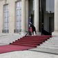 An employee cleans the red carpet of the Elysee Palace prior to the inauguration ceremony of French President Emmanuel Macron, in Paris, France, Saturday, May 7, 2022. Macron was reelected for five years on April 24 in an election runoff that saw him win over far-right rival Marine Le Pen. (AP Photo/Lewis Joly)