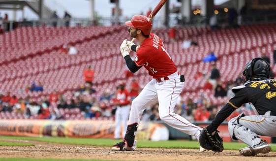 Cincinnati Reds&#39; Tyler Naquin hits a two-run double during the eighth inning in the first baseball game of a doubleheader against the Pittsburgh Pirates in Cincinnati, Saturday, May 7, 2022. The Reds won 9-2. (AP Photo/Aaron Doster)