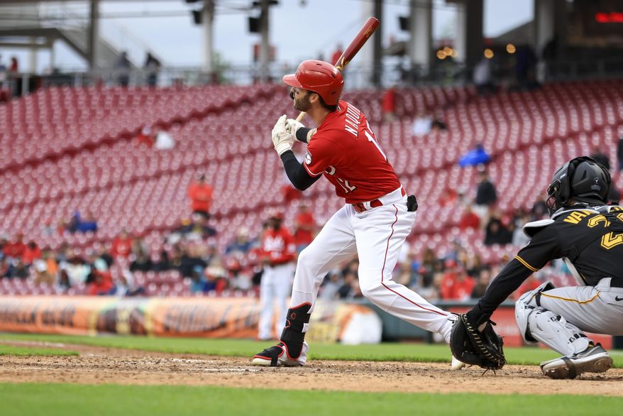Cincinnati Reds&#x27; Tyler Naquin hits a two-run double during the eighth inning in the first baseball game of a doubleheader against the Pittsburgh Pirates in Cincinnati, Saturday, May 7, 2022. The Reds won 9-2. (AP Photo/Aaron Doster)