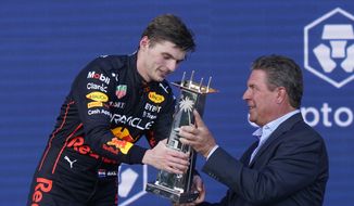 Red Bull driver Max Verstappen of the Netherlands receives the winner&#39;s trophy from former Miami Dolphins quarterback Dan Marino at the Formula One Miami Grand Prix auto race at the Miami International Autodrome, Sunday, May 8, 2022, in Miami Gardens, Fla. (AP Photo/Lynne Sladky)