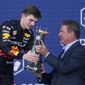 Red Bull driver Max Verstappen of the Netherlands receives the winner&#39;s trophy from former Miami Dolphins quarterback Dan Marino at the Formula One Miami Grand Prix auto race at the Miami International Autodrome, Sunday, May 8, 2022, in Miami Gardens, Fla. (AP Photo/Lynne Sladky)