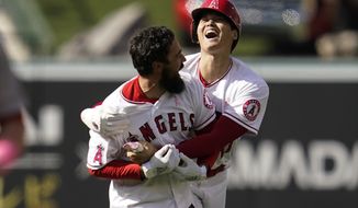 Los Angeles Angels designated hitter Shohei Ohtani (17) celebrates with Anthony Rendon (6) after a 5-4 win over the Washington Nationals in a baseball game in Anaheim, Calif., Sunday, May 8, 2022. Rendon hit a walk-off single, allowing Ohtani to score. (AP Photo/Ashley Landis)