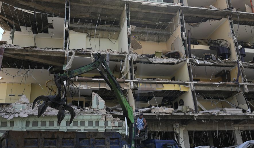 A worker operates a claw crane to remove debris from the site of Friday&#39;s deadly explosion that destroyed the five-star Hotel Saratoga, in Havana, Cuba, Saturday, May 7, 2022. (AP Photo/Ramon Espinosa)