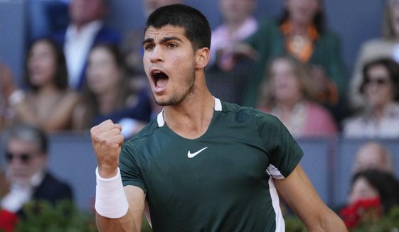 Carlos Alcaraz, of Spain, celebrates after winning a point during the final match with Alexander Zverev, of Germany, at the Mutua Madrid Open tennis tournament in Madrid, Spain, Sunday, May 8, 2022. (AP Photo/Paul White)