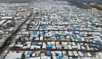 A general view of Karama camp for internally displaced Syrians, Monday, Feb. 14, 2022, by the village of Atma, Idlib province, Syria. Fallout from the 2-month-old war in Ukraine is worsening long-term humanitarian crises elsewhere, including in Syria. (AP Photo/Omar Albam, File)