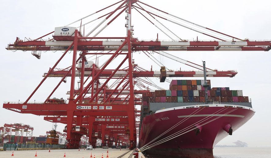 In this photo released by Xinhua News Agency, a container ship from Japan is anchored at the container dock of Shanghai&#39;s Yangshan Port in east China on April 27, 2022. China&#39;s export growth tumbled in April after Shanghai and other industrial cities were shut down to fight virus outbreaks. (Chen Jianli/Xinhua via AP)