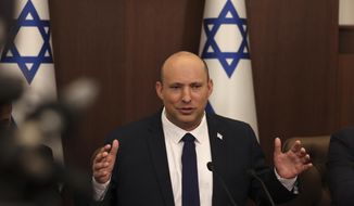 Israeli Prime Minister Naftali Bennett speaks during a weekly Cabinet meeting in Jerusalem on Sunday, May 1, 2022. Less than a year after taking office, Bennett has lost his parliamentary majority, his own party is crumbling and a key governing partner has suspended cooperation with the coalition. (Menahem Kahana/Pool Photo via AP, File)