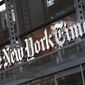 A sign for The New York Times hangs above the entrance to its building, Thursday, May 6, 2021, in New York. (AP Photo/Mark Lennihan, File)