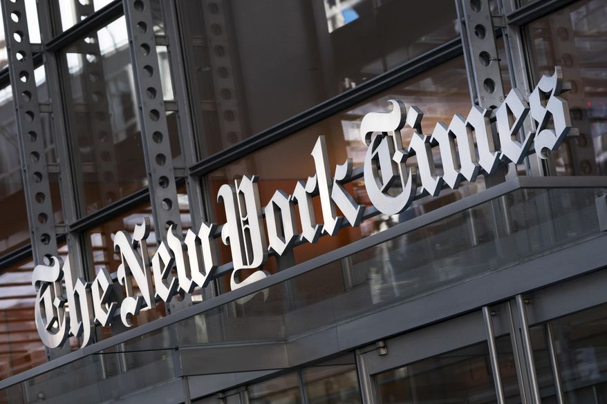A sign for The New York Times hangs above the entrance to its building, Thursday, May 6, 2021, in New York. (AP Photo/Mark Lennihan, File)