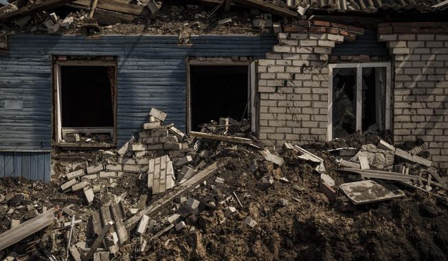 A destroyed house is seen in Malaya Rohan, a village retaken by Ukrainian forces on the outskirts of Kharkiv, Ukraine, Sunday, May 8, 2022. (AP Photo/Felipe Dana)