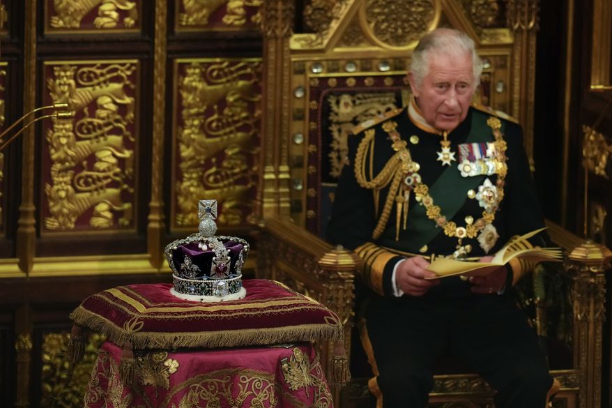 Prince Charles reads the Queen&#39;s Speech next to her crown during the State Opening of Parliament, at the Palace of Westminster in London, Tuesday, May 10, 2022. Queen Elizabeth II did not attend the opening of Parliament amid ongoing mobility issues. (AP Photo/Alastair Grant, Pool)