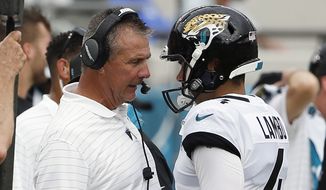 Jacksonville Jaguars head coach Urban Meyer, left, talks with place kicker Josh Lambo after Lambo missed his second field goal against the Denver Broncos during the first half of an NFL football game, Sunday, Sept. 19, 2021, in Jacksonville, Fla. Former NFL place-kicker Josh Lambo has filed a lawsuit Tuesday, May 10, 2022 against the Jacksonville Jaguars seeking more than $3.5 million in salary and damages for emotional distress caused by former head coach Urban Meyer. (AP Photo/Stephen B. Morton, File)