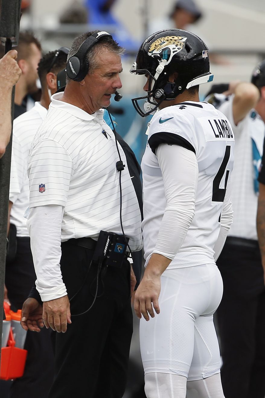 Jacksonville Jaguars head coach Urban Meyer, left, talks with place kicker Josh Lambo after Lambo missed his second field goal against the Denver Broncos during the first half of an NFL football game, Sunday, Sept. 19, 2021, in Jacksonville, Fla. Former NFL place-kicker Josh Lambo has filed a lawsuit Tuesday, May 10, 2022 against the Jacksonville Jaguars seeking more than $3.5 million in salary and damages for emotional distress caused by former head coach Urban Meyer. (AP Photo/Stephen B. Morton, File)
