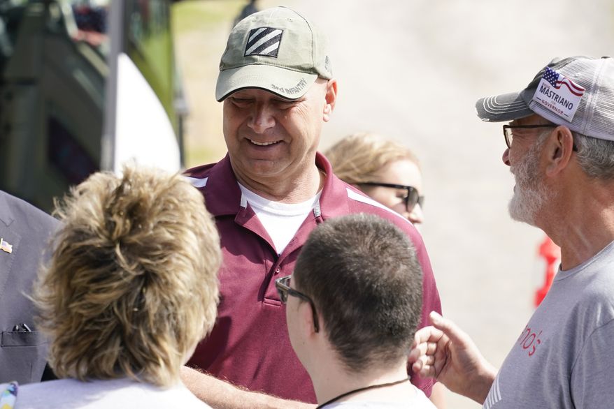 Pennsylvania state Sen. Doug Mastriano, R-Franklin, left, a Republican running for Governor of Pennsylvania, arrives at a campaign stop Tuesday, May 10, 2022, in Portersville, Pa. (AP Photo/Keith Srakocic)