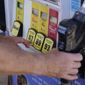 A customer pumps gas at a Shell gas station, Tuesday, May 10, 2022, in Miami. (AP Photo/Marta Lavandier)