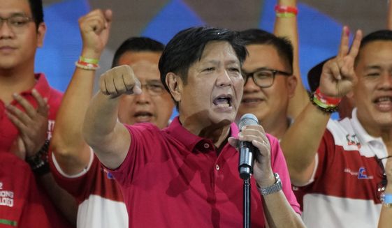 Former Sen. Ferdinand &quot;Bongbong&quot; Marcos Jr., the son of the late dictator, gestures as he greets the crowd during a presidential campaign rally in Quezon City, Philippines on April 13, 2022. Marcos Jr.&#39;s apparent landslide victory in the Philippine presidential election is giving rise to immediate concerns about a further erosion of democracy in the region, and could complicate American efforts to blunt growing Chinese influence and power in the Pacific. (AP Photo/Aaron Favila, File)
