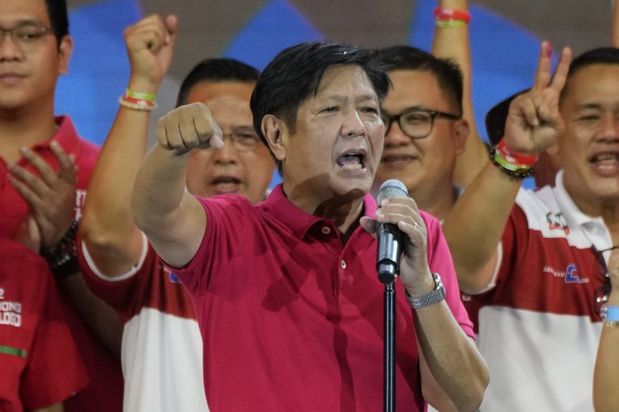 Former Sen. Ferdinand "Bongbong" Marcos Jr., the son of the late dictator, gestures as he greets the crowd during a presidential campaign rally in Quezon City, Philippines on April 13, 2022. Marcos Jr.'s apparent landslide victory in the Philippine presidential election is giving rise to immediate concerns about a further erosion of democracy in the region, and could complicate American efforts to blunt growing Chinese influence and power in the Pacific. (AP Photo/Aaron Favila, File)