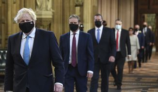 Britain&#39;s Prime Minister Boris Johnson, left, and Labour Party leader Keir Starmer, second left, walk through the Central Lobby on the way to the House of Lords prior to Queen Elizabeth II delivering a speech during the State Opening of Parliament in the House of Lords at the Palace of Westminster in London, on May 11, 2021. Britain’s Parliament opens a new yearlong session on Tuesday, May 10, 2022, with a mix of royal pomp and raw politics, as Johnson tries to reenergize his scandal-tarnished administration and address the U.K.’s worsening cost-of-living crisis. (Stefan Rousseau/Pool via AP)