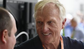Professional golfer Greg Norman walks through the pit area during the third practice session for the Formula One Miami Grand Prix auto race at the Miami International Autodrome, Saturday, May 7, 2022, in Miami Gardens, Fla. (AP Photo/Darron Cummings) **FILE**