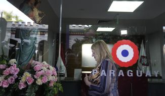 Attorney General of Paraguay Sandra Quiñonez prays to a Virgin Mary statue at the entrance of her office in Asuncion, Paraguay, Tuesday, May 10, 2022, after she found out about the killing of Paraguayan prosecutor Marcelo Pecci during his honeymoon in Colombia. (AP Photo/Jorge Saenz) ** FILE **