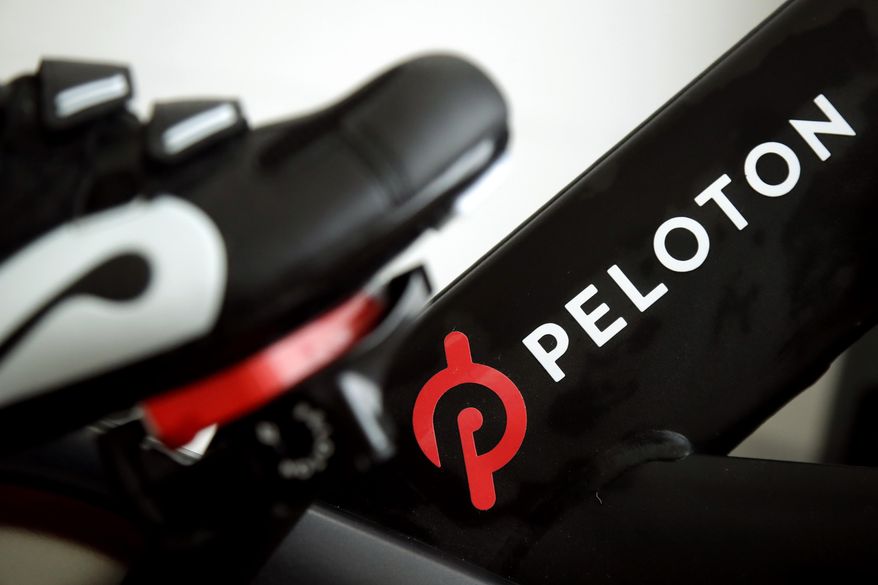 This Nov. 19, 2019 file photo shows the logo on a Peloton bike in San Francisco. Peloton&#39;s loss widened in its fiscal third quarter and sales continued to slow as the company contends with a further cooling of the exercise-at-home trend. Shares tumbled more than 25% before the market open on Tuesday, May 10, 2022. (AP Photo/Jeff Chiu, File)