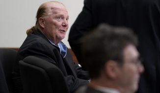 Celebrity chef Mario Batali, left, speaks with his defense attorney Anthony Fuller, arms only at right, as prosecutor Ian Polumbaum is seated, below right, during a break in proceedings on the first day of Batali&#39;s pandemic-delayed trial, at Boston Municipal Court, Monday, May 9, 2022, in Boston. Batali pleaded not guilty to a charge of indecent assault and battery in 2019, stemming from accusations that he forcibly kissed and groped a woman after taking a selfie with her at a Boston restaurant in 2017. (AP Photo/Steven Senne, Pool)