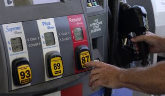 A customer pumps gas at an Exxon gas station, Tuesday, May 10, 2022, in Miami. (AP Photo/Marta Lavandier)