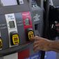 A customer pumps gas at an Exxon gas station, Tuesday, May 10, 2022, in Miami. (AP Photo/Marta Lavandier)