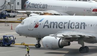 American Airlines passenger jets prepare for departure, Wednesday, July 21, 2021, near a terminal at Boston Logan International Airport, in Boston. (AP Photo/Steven Senne, File)