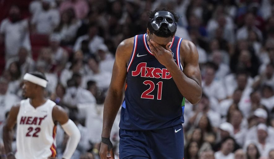 Philadelphia 76ers center Joel Embiid (21) wipes his face during the second half of Game 5 of an NBA basketball second-round playoff series against the Miami Heat, Tuesday, May 10, 2022, in Miami. (AP Photo/Wilfredo Lee) **FILE**