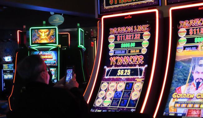 A gambler wins at a slot machine at the Ocean Casino Resort in Atlantic City, N.J., Feb. 10, 2022. The American Gaming Association said Wednesday, May 11, 2022, that America&#x27;s commercial casinos had their best month ever in March 2022, winning $5.3 billion from gamblers. (AP Photo/Wayne Parry)