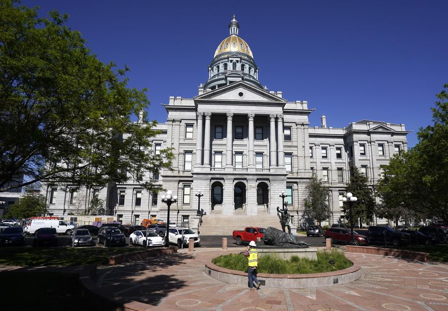 In this May 28, 2021, photo, the morning sun shines on the State Capitol shines in downtown Denver. (AP Photo/David Zalubowski, File)