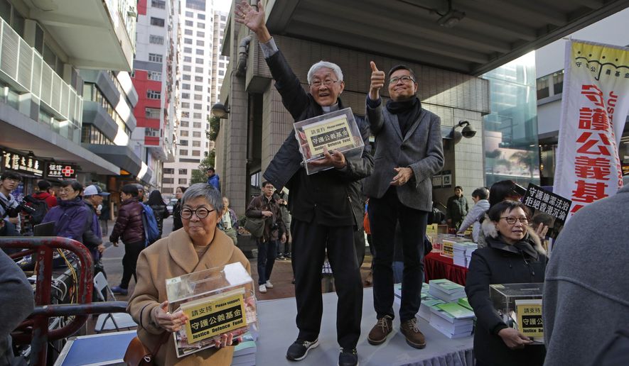 Retired archbishop of Hong Kong Cardinal Joseph Zen, center, and pro-democracy activist and barrister Margaret Ng, left, hold the donation boxes during an annual New Year protest in Hong Kong, Tuesday, Jan. 1, 2019. Reports say a Roman Catholic cardinal and three others have been arrested in Hong Kong on suspicion of colluding with foreign forces to endanger Chinese national security. U.K.-based human rights group Hong Kong Watch said Cardinal Joseph Zen, lawyer Margaret Ng, singer Denise Ho and scholar Hui Po-keung were detained Wednesday, May 11, 2022, by Hong Kong&#39;s National Security Police. (AP Photo/Kin Cheung)