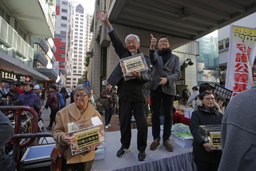 Retired archbishop of Hong Kong Cardinal Joseph Zen, center, and pro-democracy activist and barrister Margaret Ng, left, hold the donation boxes during an annual New Year protest in Hong Kong, Tuesday, Jan. 1, 2019. Reports say a Roman Catholic cardinal and three others have been arrested in Hong Kong on suspicion of colluding with foreign forces to endanger Chinese national security. U.K.-based human rights group Hong Kong Watch said Cardinal Joseph Zen, lawyer Margaret Ng, singer Denise Ho and scholar Hui Po-keung were detained Wednesday, May 11, 2022, by Hong Kong&#x27;s National Security Police. (AP Photo/Kin Cheung)