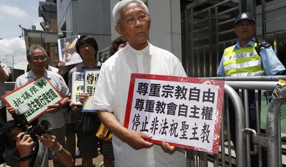 Hong Kong&#x27;s outspoken Cardinal Joseph Zen, center, and other religious protesters hold placards with &quot;Respects religious freedom&quot; written on them during a demonstration outside the China Liaison Office in Hong Kong, Wednesday, July 11, 2012. Reports say a Roman Catholic cardinal and three others have been arrested in Hong Kong on suspicion of colluding with foreign forces to endanger Chinese national security. U.K.-based human rights group Hong Kong Watch said Cardinal Joseph Zen, lawyer Margaret Ng, singer Denise Ho and scholar Hui Po-keung were detained Wednesday, May 11, 2022, by Hong Kong&#x27;s National Security Police. (AP Photo/Kin Cheung, File)