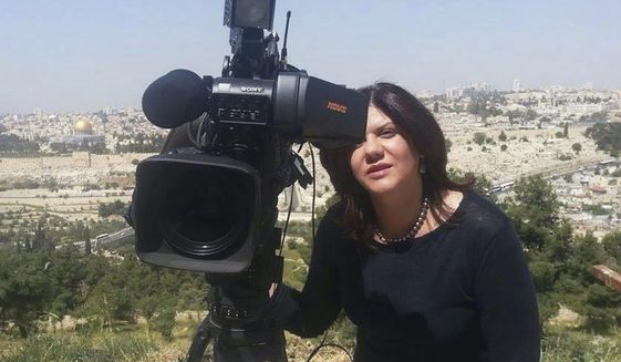 In this undated photo provided by Al Jazeera Media Network, Shireen Abu Akleh, a journalist for Al Jazeera network, stands next to a TV camera in an area where the Dome of the Rock shrine at Al-Aqsa Mosque in the Old City of Jerusalem is seen at left in the background. Abu Akleh, a well-known Palestinian female reporter for the broadcaster&#39;s Arabic language channel, was shot and killed while covering an Israeli raid in the occupied West Bank town of Jenin early Wednesday, May 11, 2022. (Al Jazeera Media Network via AP)