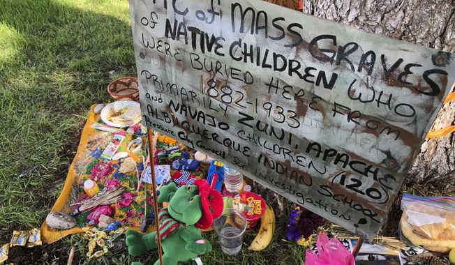 FILE - A makeshift memorial for the dozens of Indigenous children who died more than a century ago while attending a boarding school that was once located nearby is displayed under a tree at a public park in Albuquerque, N.M., on  July 1, 2021. The U.S. Interior Department is expected to release a report Wednesday, May 11, 2022, that it says will begin to uncover the truth about the federal government&#x27;s past oversight of Native American boarding schools. (AP Photo/Susan Montoya Bryan, File)