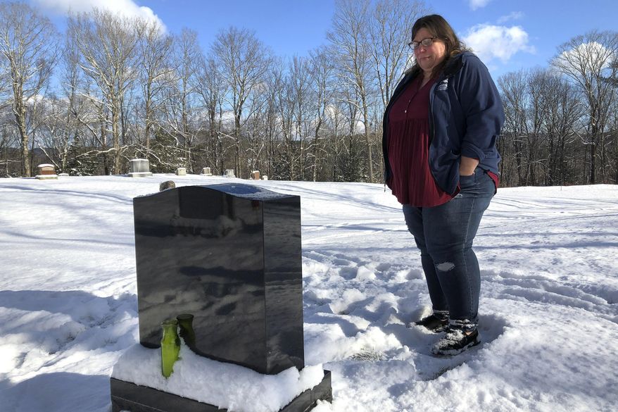 Deb Walker visits the grave of her daughter, Brooke Goodwin, Thursday, Dec. 9, 2021, in Chester, Vt. Goodwin, 23, died in March of 2021 of a fatal overdose of the powerful opioid fentanyl and xylazine, an animal tranquilizer that is making its way into the illicit drug supply. According to provisional data released by the Centers for Disease Control and Prevention on Wednesday, May 11, 2022, more than 107,000 Americans died of drug overdoses in 2021, setting another tragic record in the nation’s escalating overdose epidemic. (AP Photo/Lisa Rathke, File)