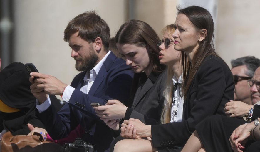 Kateryna Prokopenko, center, wife of Azov Commander Denys Prokopenko, and Yuliia Fedosiuk, second from left, from Ukraine attend Pope Francis weekly general audience in St. Peter&#39;s Square at the Vatican, Wednesday, May 11, 2022. (AP Photo/Gregorio Borgia