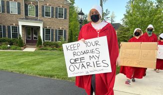 Protesters outfitted as characters from &quot;The Handmaid&#39;s Tale&quot; are shown here demonstrating outside the home of Supreme Court Justice Amy Coney Barrett in Falls Church, Va., on May 11, 2022. Photo by Douglas Blair courtesy of the Daily Signal.